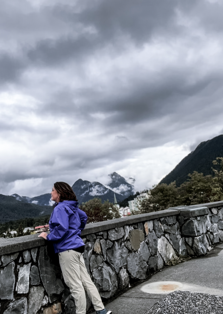 Woman overlooking mountain panorama at Baranof Castle Hill
